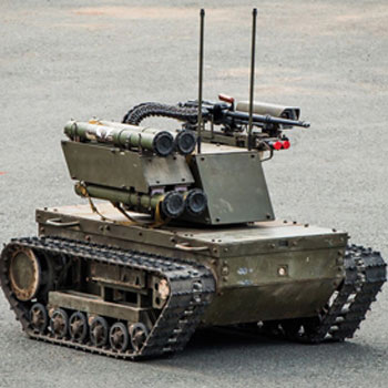 Defense robot with tank-like treads, sensors, and communication antennas for remote operation and autonomous navigation.