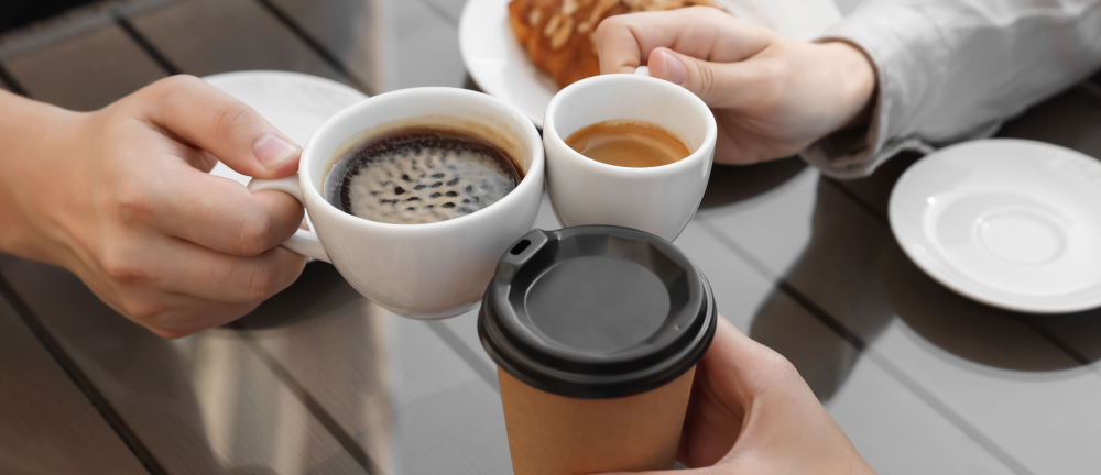 Banner image of three colleagues raising their coffee cups in a toast before the show.