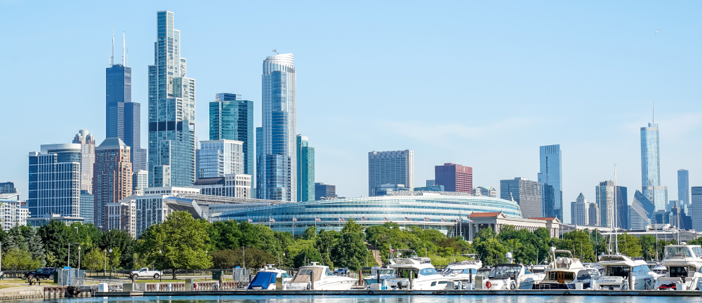 Banner image of the Chicago Skyline rising above Lake Michigan in a panoramic view from Burnham Harbor.
