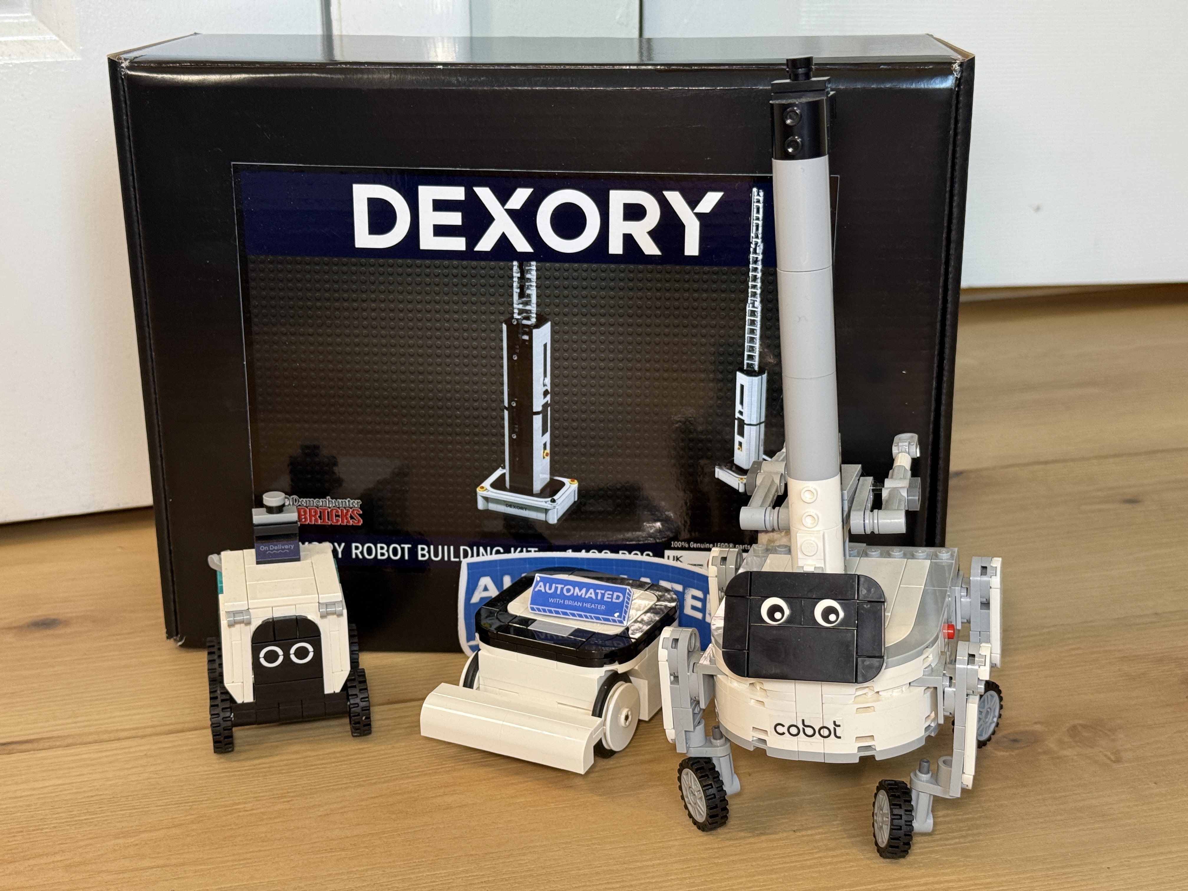 Robot plastic brick building set prizes from Dexory and Cobot with Automated sticker