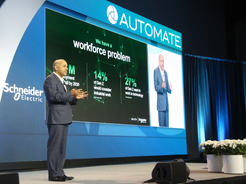 Man speaks to a classroom at Automate Show. Decorative Image.