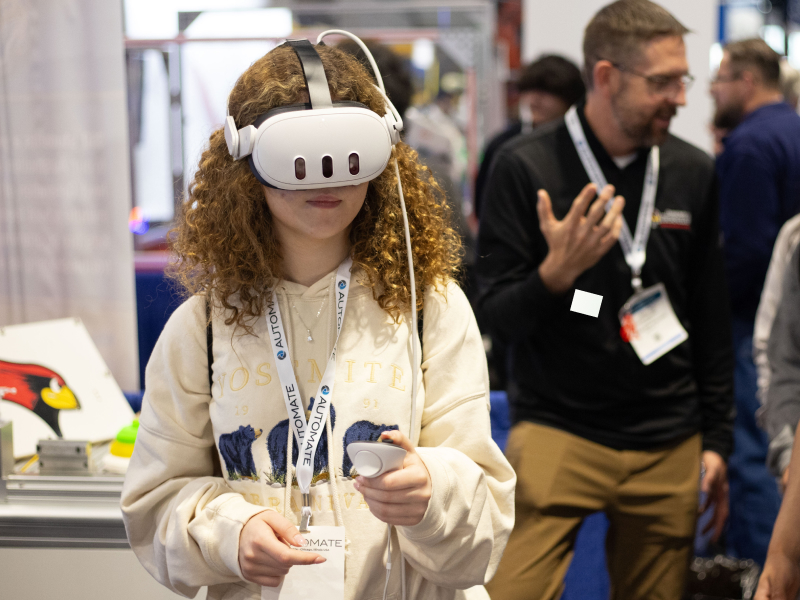 Automate Student Challenge - student using a virtual reality headset with controller